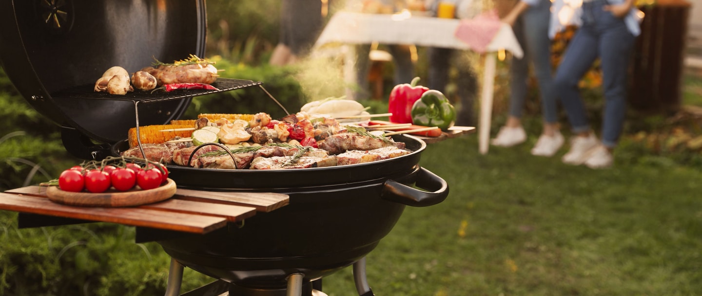A backyard grill filled with various foods